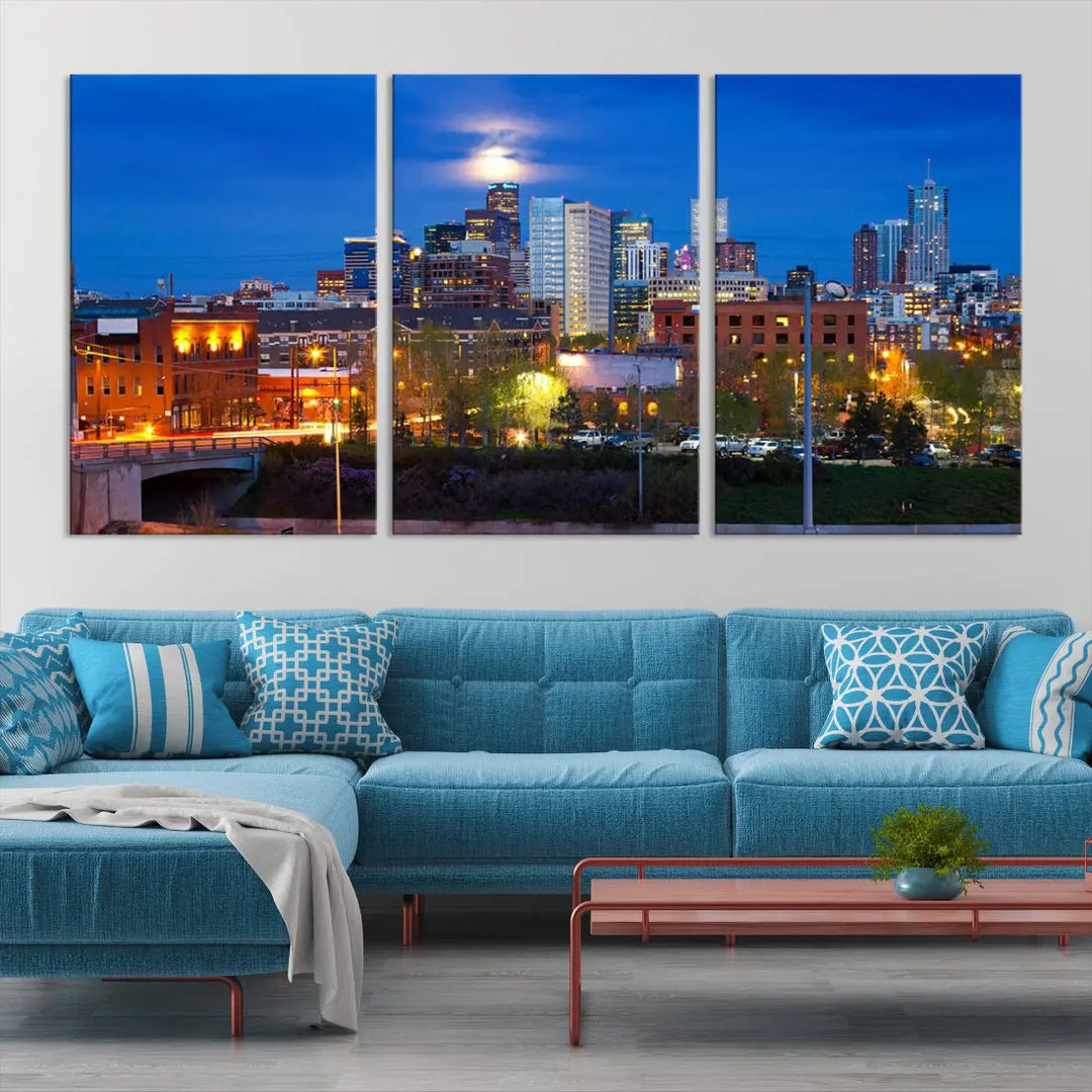 The Denver City Lights Night Blue Skyline Cityscape View Wall Art Canvas Print showcases a stunning night cityscape. Printed on museum-quality canvas with a UV-protective coating, this artwork comes ready to hang, adding an effortless touch of elegance.