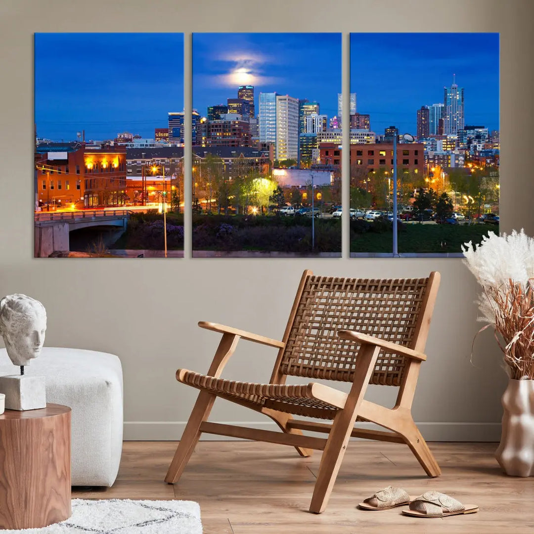 The Denver City Lights Night Blue Skyline Cityscape View Wall Art Canvas Print showcases a stunning night cityscape. Printed on museum-quality canvas with a UV-protective coating, this artwork comes ready to hang, adding an effortless touch of elegance.