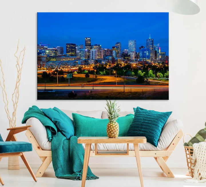 A modern living room showcases the "Denver City Lights Night Blue Skyline Cityscape View Wall Art Canvas Print" in a triptych arrangement. These museum-quality canvases, finished with a UV-protective coating, maintain their vibrant allure.