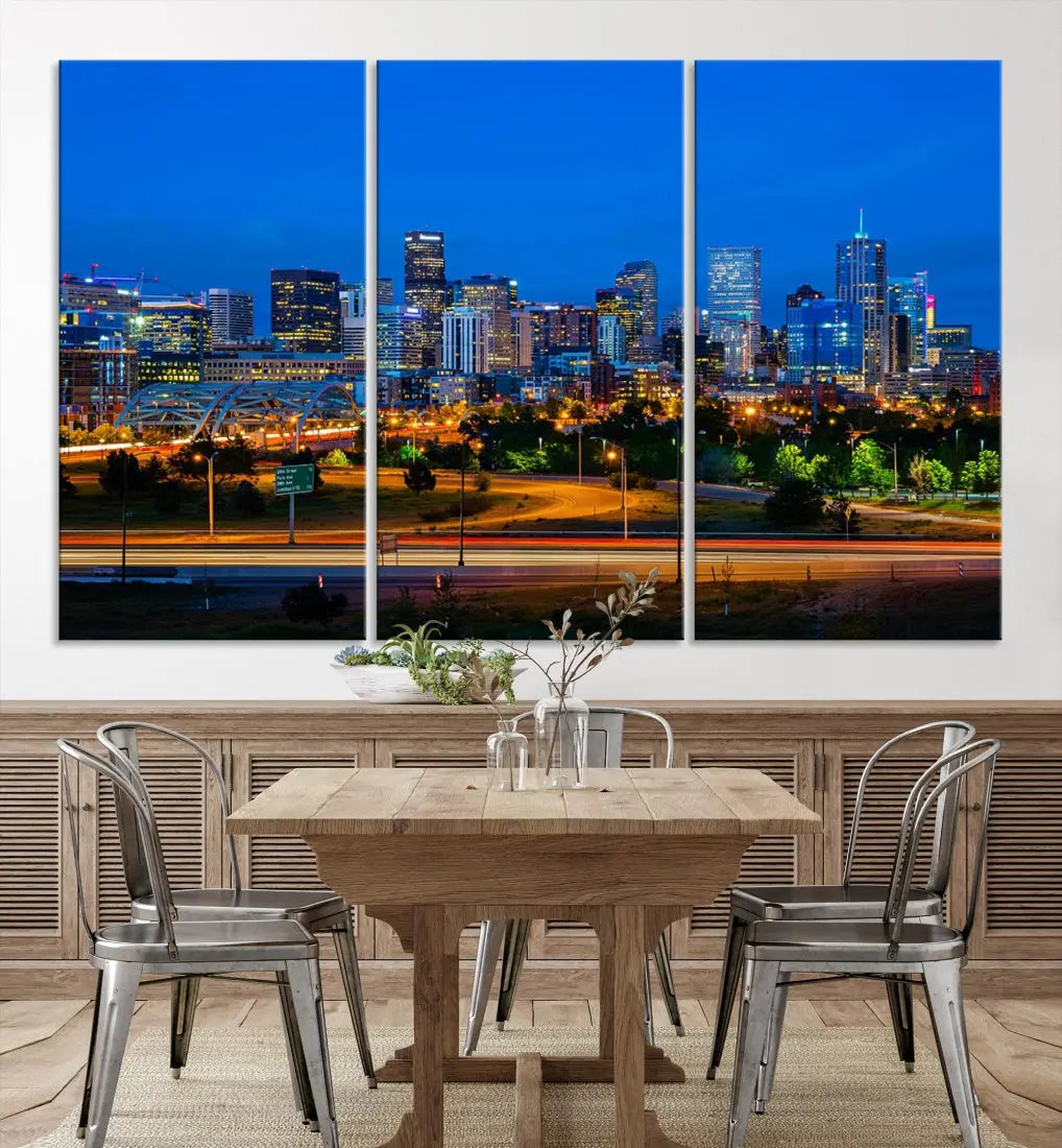 A modern living room showcases the "Denver City Lights Night Blue Skyline Cityscape View Wall Art Canvas Print" in a triptych arrangement. These museum-quality canvases, finished with a UV-protective coating, maintain their vibrant allure.