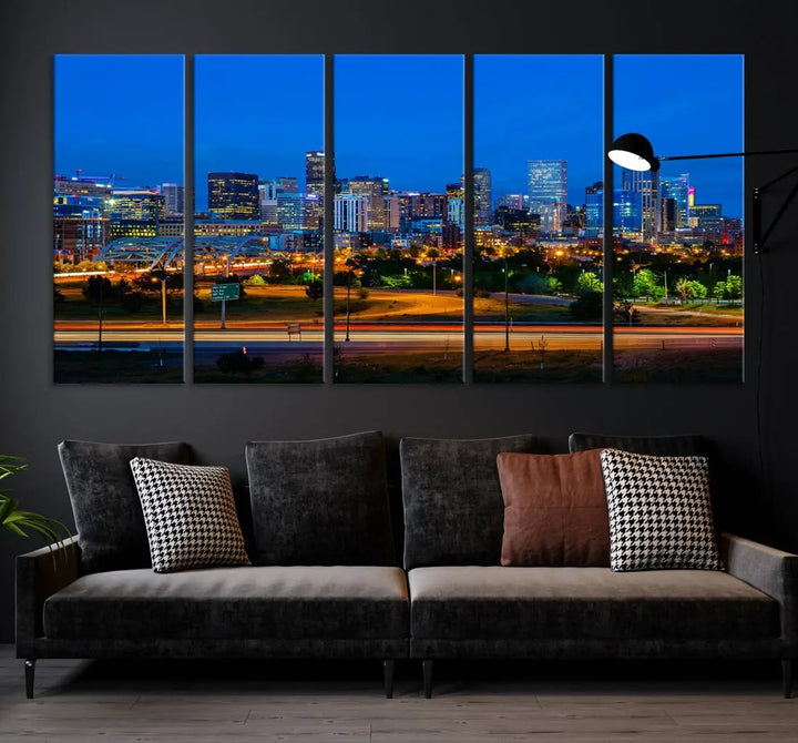 A modern living room showcases the "Denver City Lights Night Blue Skyline Cityscape View Wall Art Canvas Print" in a triptych arrangement. These museum-quality canvases, finished with a UV-protective coating, maintain their vibrant allure.