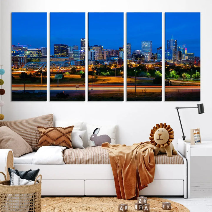 A modern living room showcases the "Denver City Lights Night Blue Skyline Cityscape View Wall Art Canvas Print" in a triptych arrangement. These museum-quality canvases, finished with a UV-protective coating, maintain their vibrant allure.