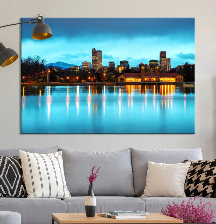 A living room in teal and brown decor showcases the "Denver City Lights Night Bright Turquoise Skyline Cityscape View" wall art canvas print above the couch. This large, museum-quality piece comes with a UV-protective coating.