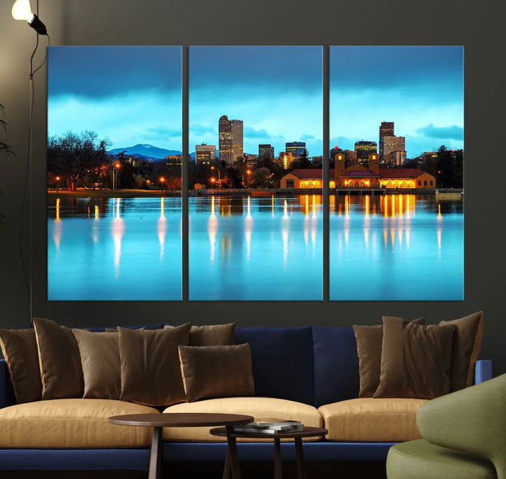 A living room in teal and brown decor showcases the "Denver City Lights Night Bright Turquoise Skyline Cityscape View" wall art canvas print above the couch. This large, museum-quality piece comes with a UV-protective coating.