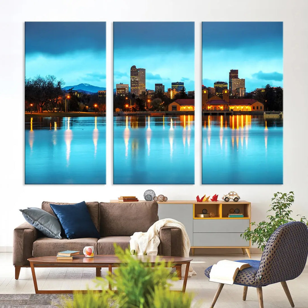 A living room in teal and brown decor showcases the "Denver City Lights Night Bright Turquoise Skyline Cityscape View" wall art canvas print above the couch. This large, museum-quality piece comes with a UV-protective coating.