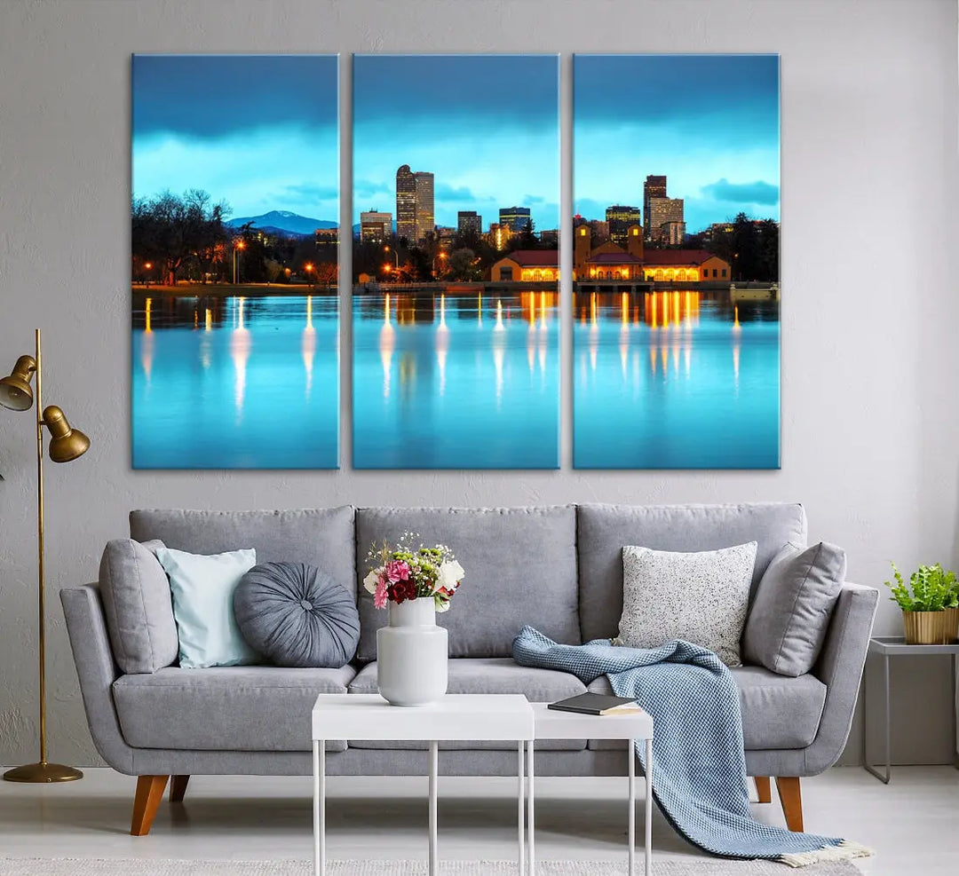 A living room in teal and brown decor showcases the "Denver City Lights Night Bright Turquoise Skyline Cityscape View" wall art canvas print above the couch. This large, museum-quality piece comes with a UV-protective coating.