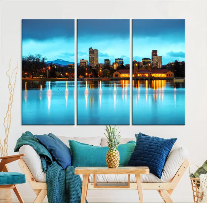 A living room in teal and brown decor showcases the "Denver City Lights Night Bright Turquoise Skyline Cityscape View" wall art canvas print above the couch. This large, museum-quality piece comes with a UV-protective coating.