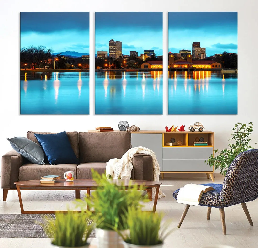 A living room in teal and brown decor showcases the "Denver City Lights Night Bright Turquoise Skyline Cityscape View" wall art canvas print above the couch. This large, museum-quality piece comes with a UV-protective coating.