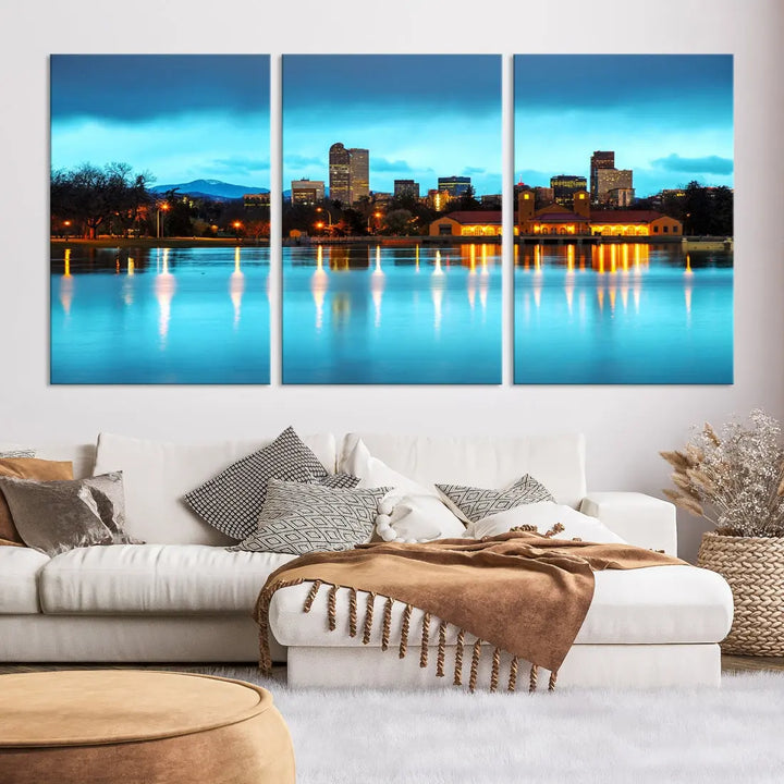 A living room in teal and brown decor showcases the "Denver City Lights Night Bright Turquoise Skyline Cityscape View" wall art canvas print above the couch. This large, museum-quality piece comes with a UV-protective coating.