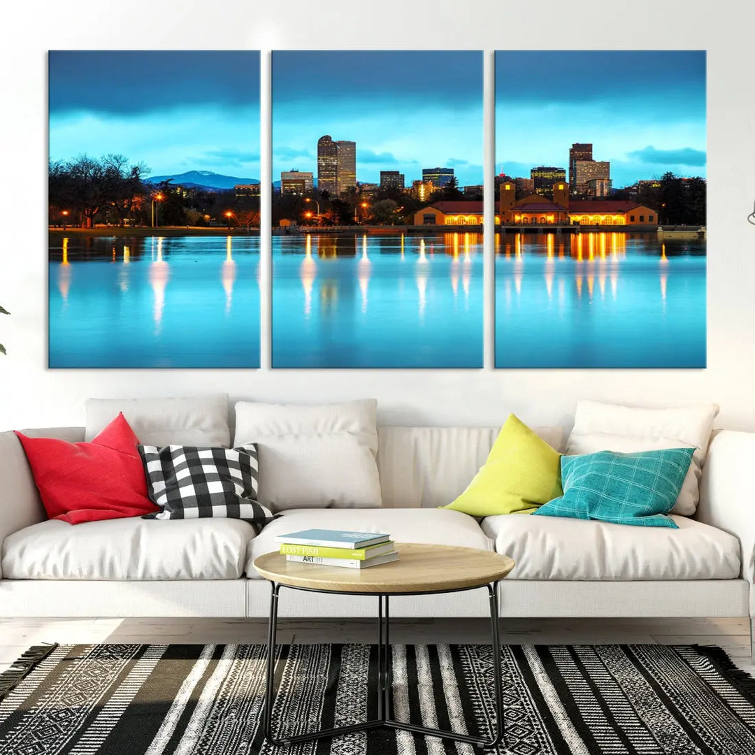 A living room in teal and brown decor showcases the "Denver City Lights Night Bright Turquoise Skyline Cityscape View" wall art canvas print above the couch. This large, museum-quality piece comes with a UV-protective coating.