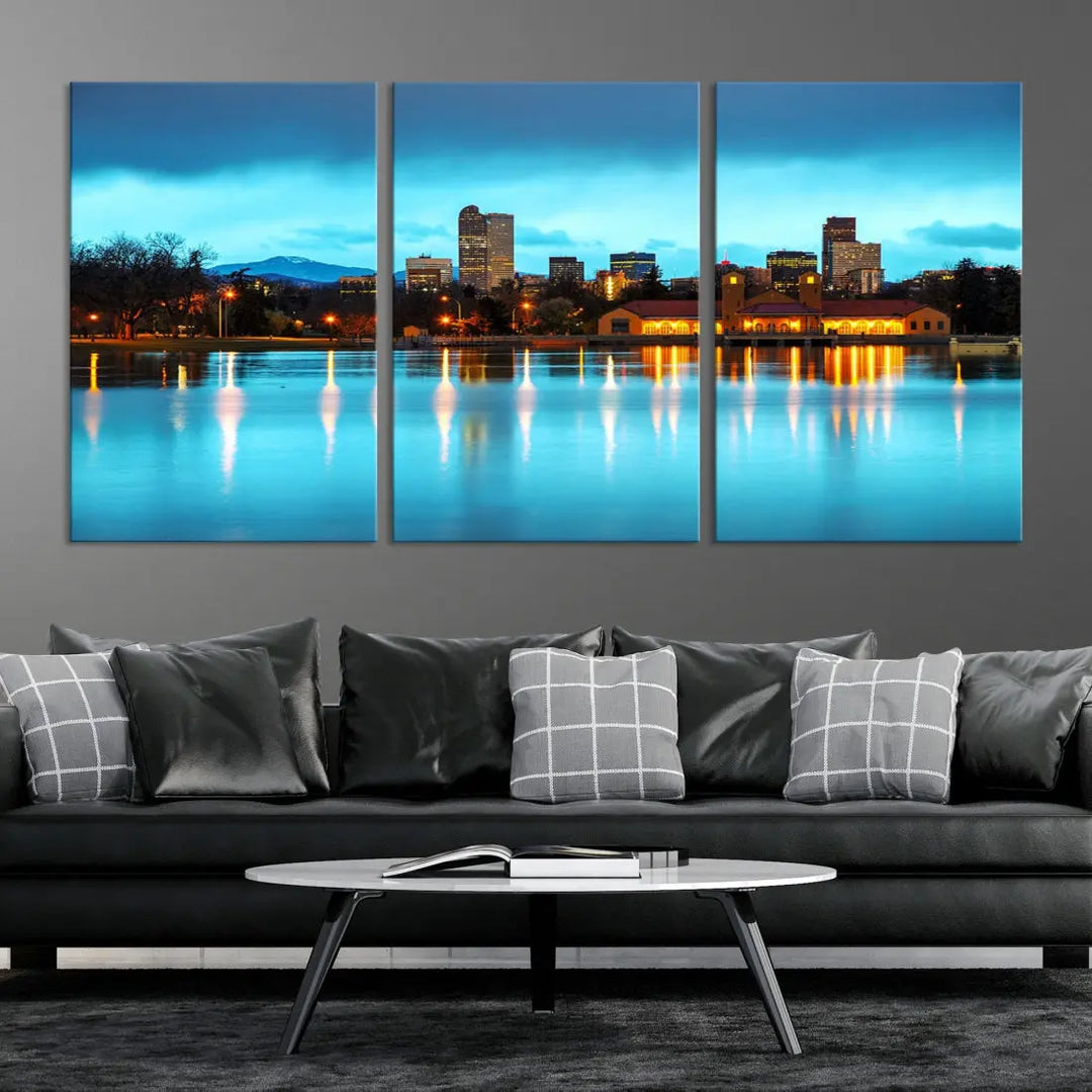 A living room in teal and brown decor showcases the "Denver City Lights Night Bright Turquoise Skyline Cityscape View" wall art canvas print above the couch. This large, museum-quality piece comes with a UV-protective coating.