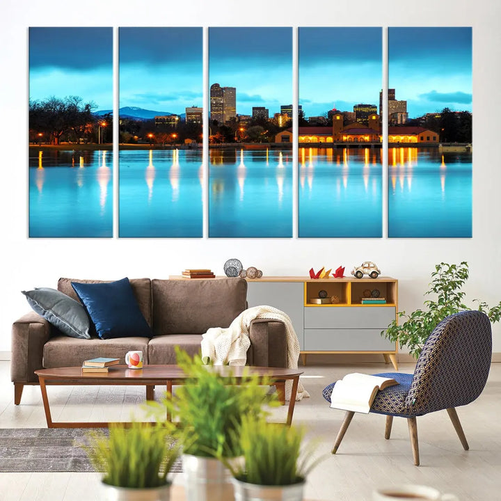 A living room in teal and brown decor showcases the "Denver City Lights Night Bright Turquoise Skyline Cityscape View" wall art canvas print above the couch. This large, museum-quality piece comes with a UV-protective coating.