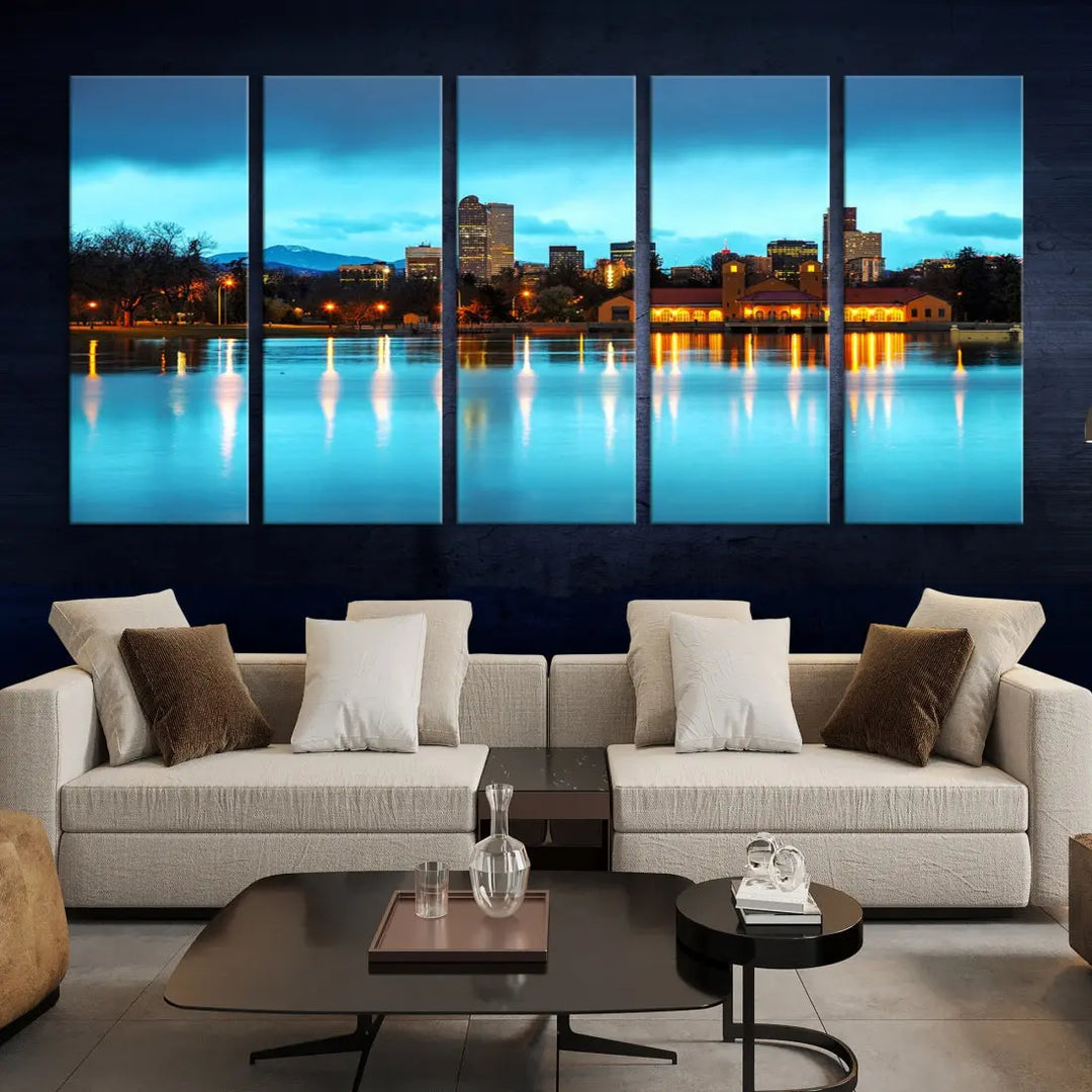 A living room in teal and brown decor showcases the "Denver City Lights Night Bright Turquoise Skyline Cityscape View" wall art canvas print above the couch. This large, museum-quality piece comes with a UV-protective coating.