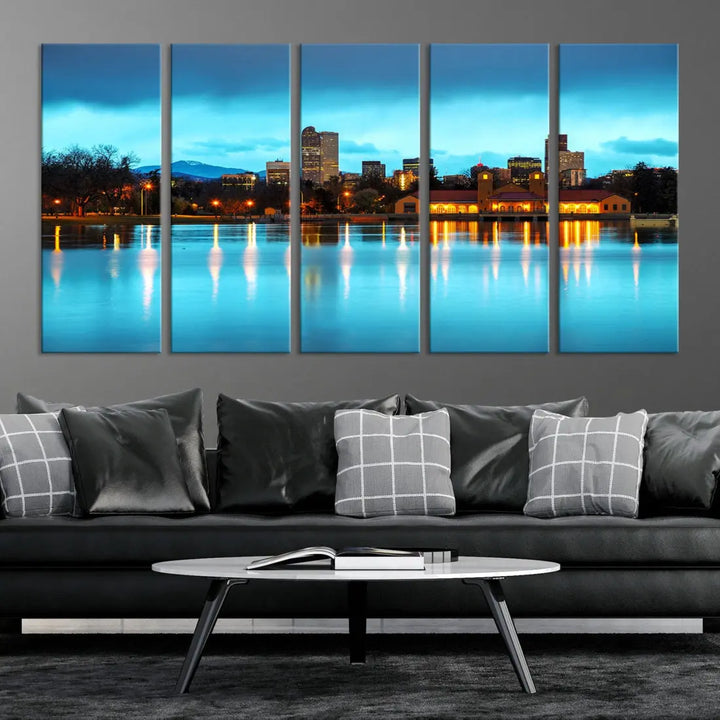 A living room in teal and brown decor showcases the "Denver City Lights Night Bright Turquoise Skyline Cityscape View" wall art canvas print above the couch. This large, museum-quality piece comes with a UV-protective coating.