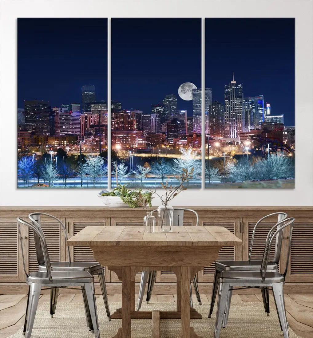 A cozy living room features the "Denver City Lights Night with Full Moon Skyline Cityscape View" wall art canvas print, gallery wrapped on museum-quality canvas.