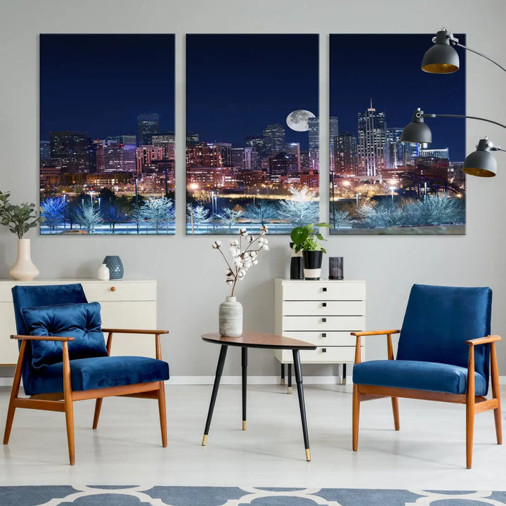 A cozy living room features the "Denver City Lights Night with Full Moon Skyline Cityscape View" wall art canvas print, gallery wrapped on museum-quality canvas.