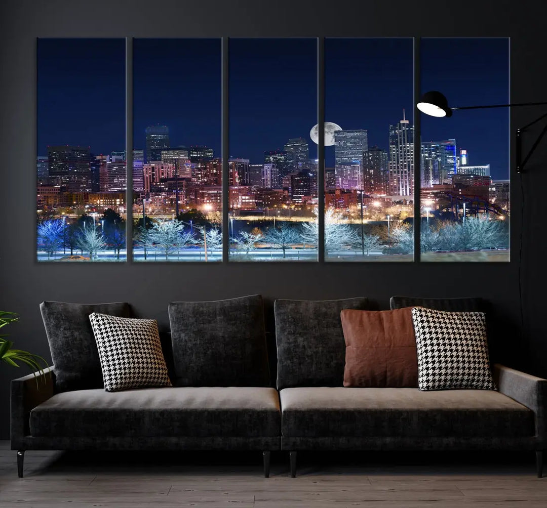 A cozy living room features the "Denver City Lights Night with Full Moon Skyline Cityscape View" wall art canvas print, gallery wrapped on museum-quality canvas.