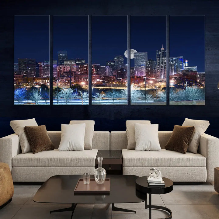 A cozy living room features the "Denver City Lights Night with Full Moon Skyline Cityscape View" wall art canvas print, gallery wrapped on museum-quality canvas.