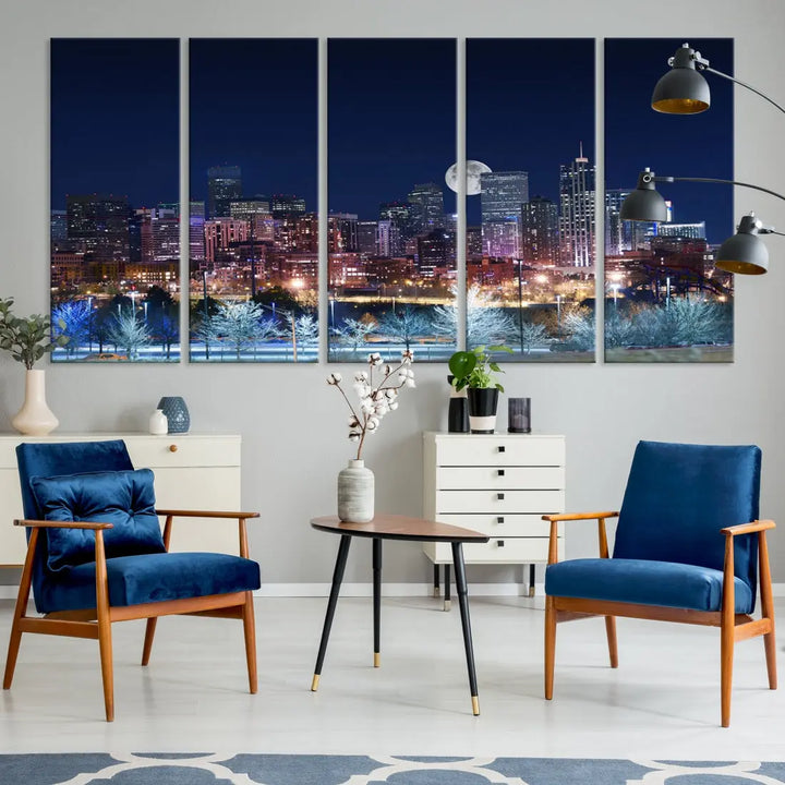 A cozy living room features the "Denver City Lights Night with Full Moon Skyline Cityscape View" wall art canvas print, gallery wrapped on museum-quality canvas.