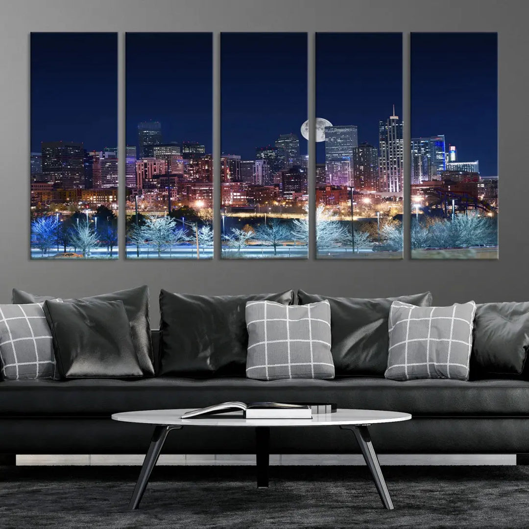 A cozy living room features the "Denver City Lights Night with Full Moon Skyline Cityscape View" wall art canvas print, gallery wrapped on museum-quality canvas.