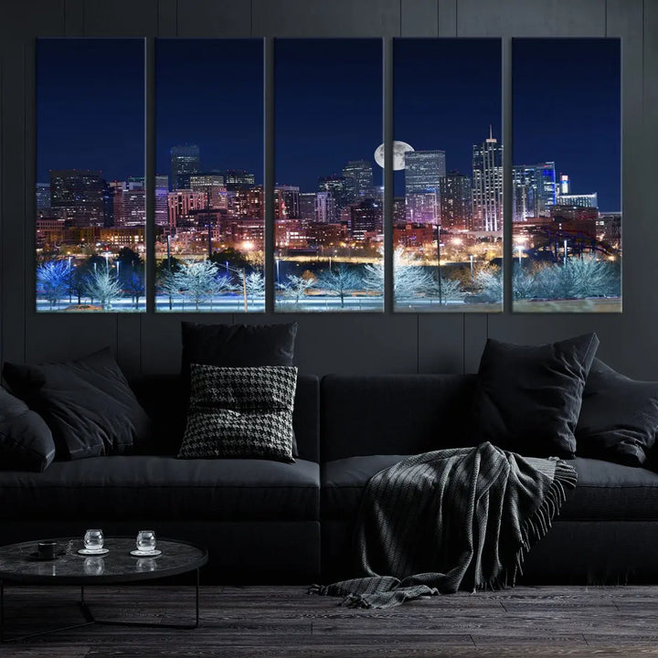 A cozy living room features the "Denver City Lights Night with Full Moon Skyline Cityscape View" wall art canvas print, gallery wrapped on museum-quality canvas.