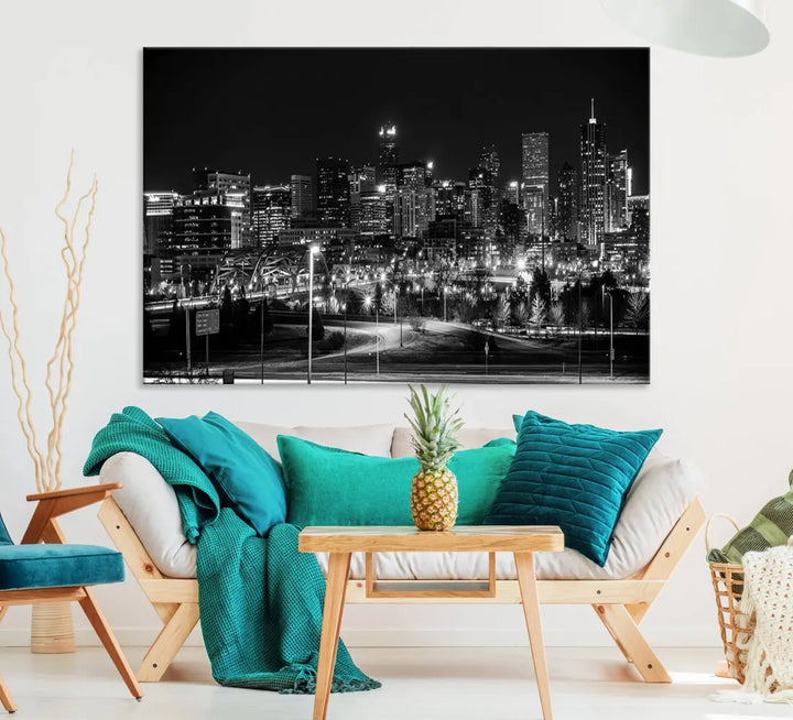 A modern living room featuring the Denver City Lights Skyline Black and White Cityscape Canvas Print above a sofa.