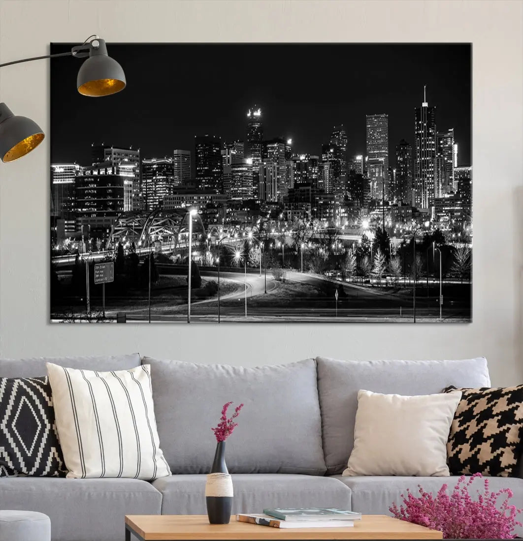 A modern living room featuring the Denver City Lights Skyline Black and White Cityscape Canvas Print above a sofa.