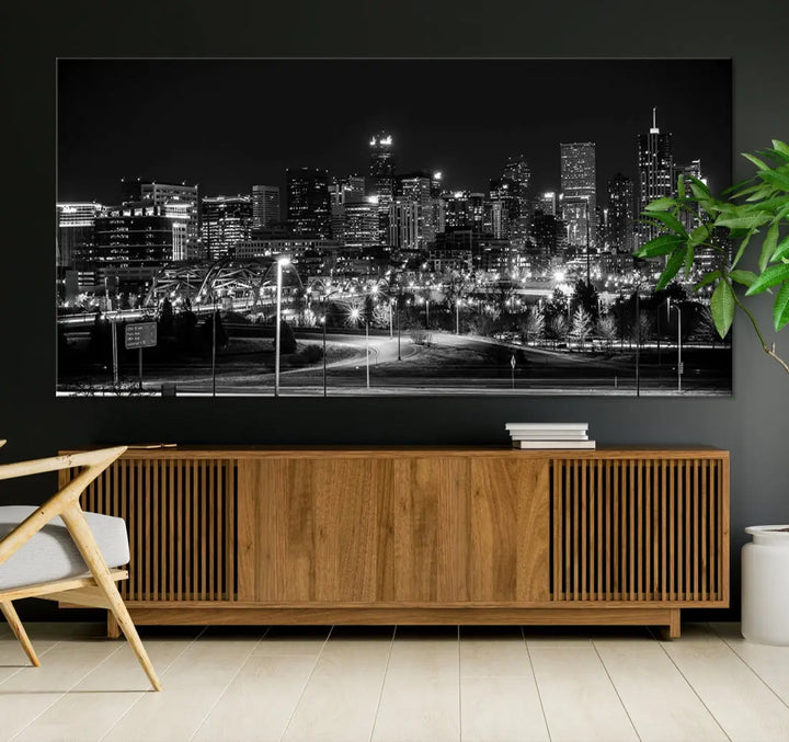 A modern living room featuring the Denver City Lights Skyline Black and White Cityscape Canvas Print above a sofa.