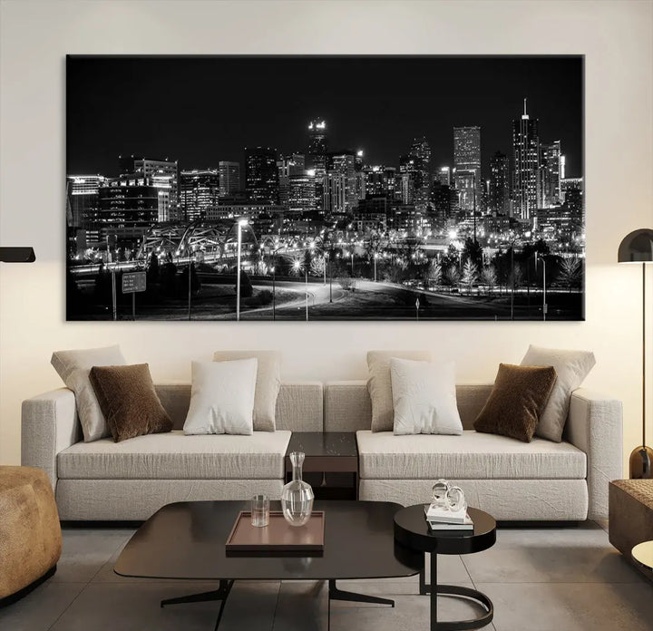 A modern living room featuring the Denver City Lights Skyline Black and White Cityscape Canvas Print above a sofa.