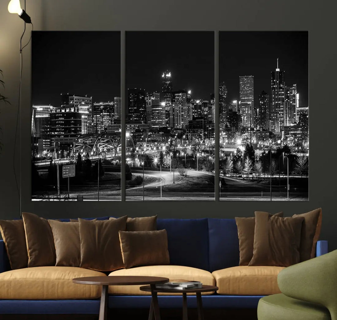 A modern living room featuring the Denver City Lights Skyline Black and White Cityscape Canvas Print above a sofa.