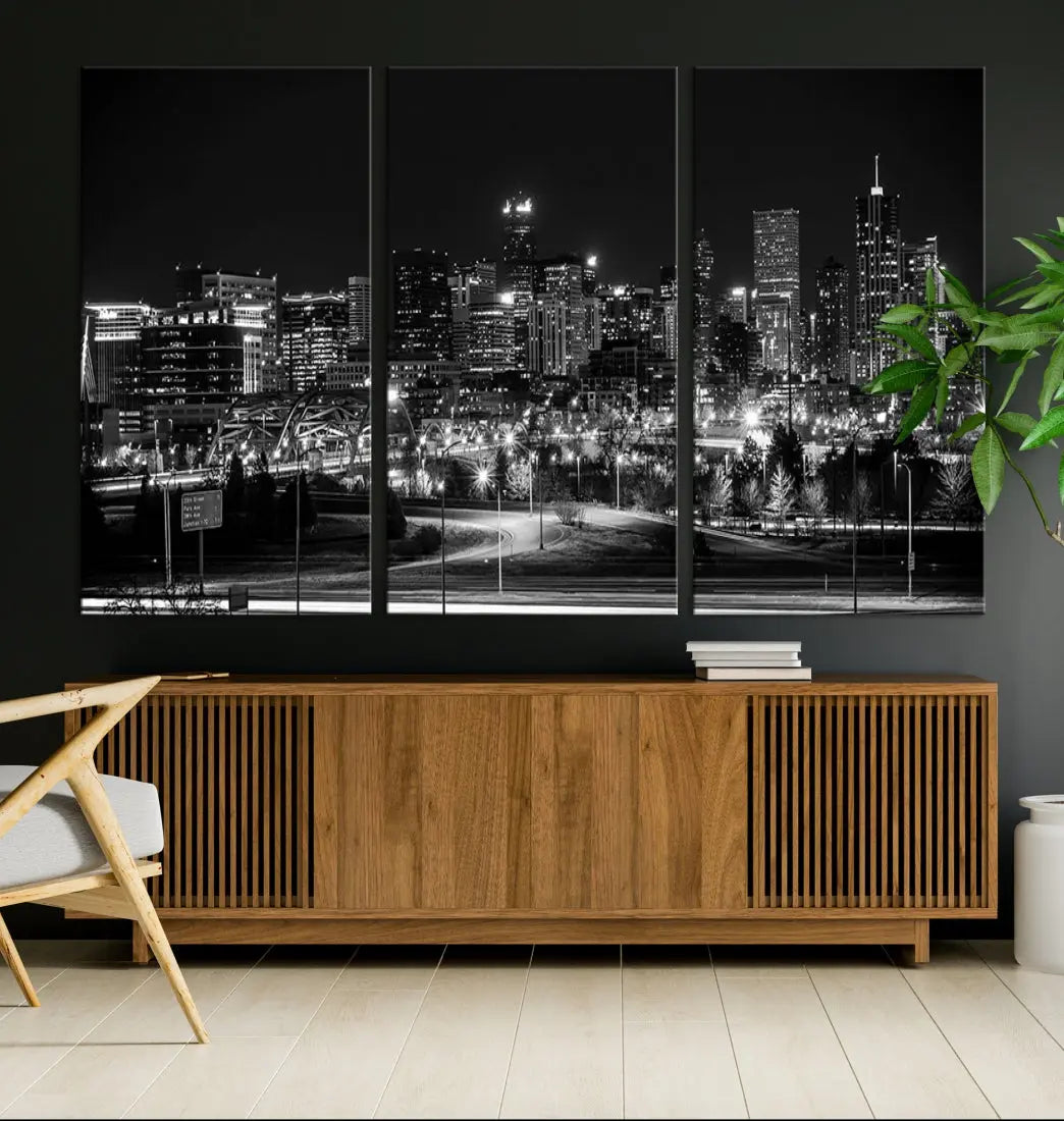 A modern living room featuring the Denver City Lights Skyline Black and White Cityscape Canvas Print above a sofa.