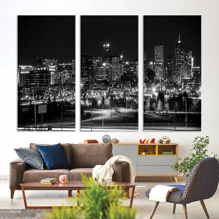 A modern living room featuring the Denver City Lights Skyline Black and White Cityscape Canvas Print above a sofa.