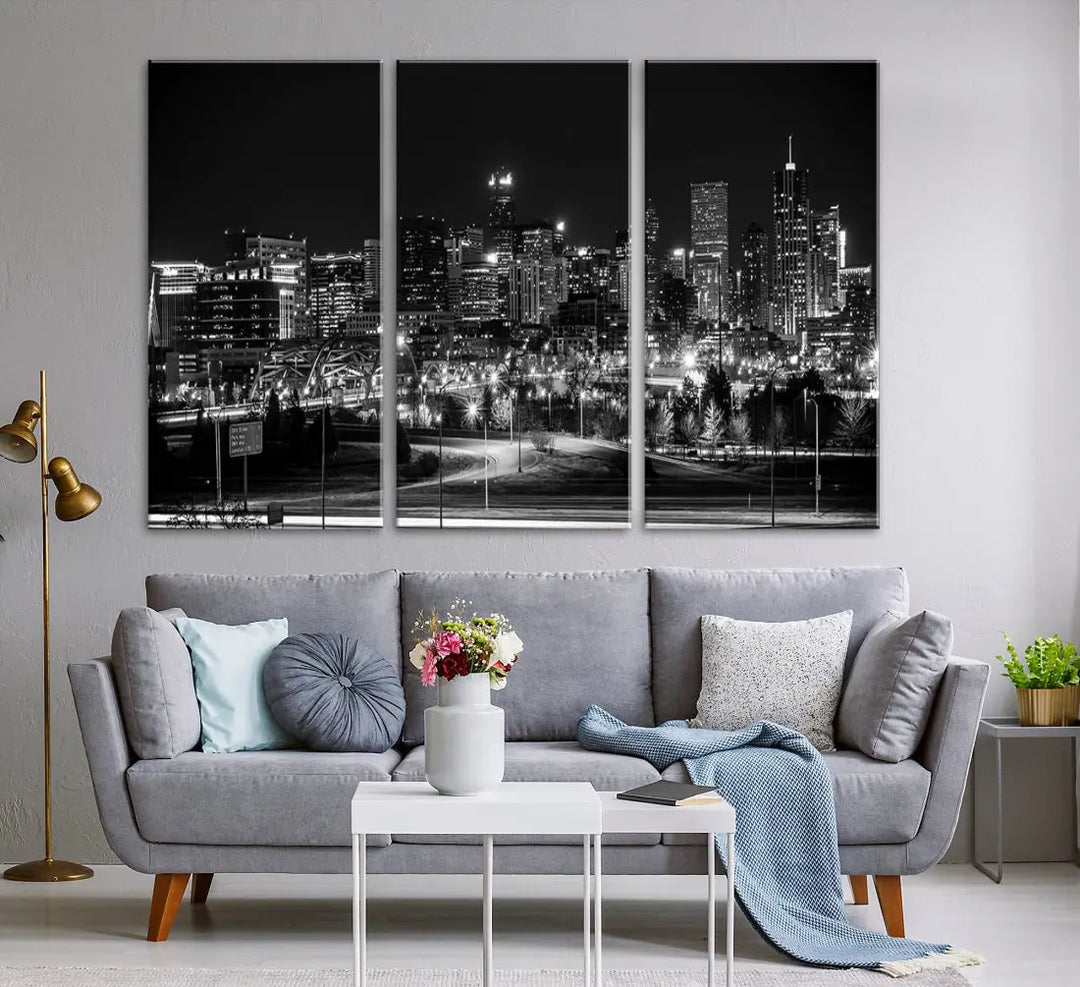 A modern living room featuring the Denver City Lights Skyline Black and White Cityscape Canvas Print above a sofa.