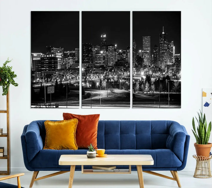 A modern living room featuring the Denver City Lights Skyline Black and White Cityscape Canvas Print above a sofa.