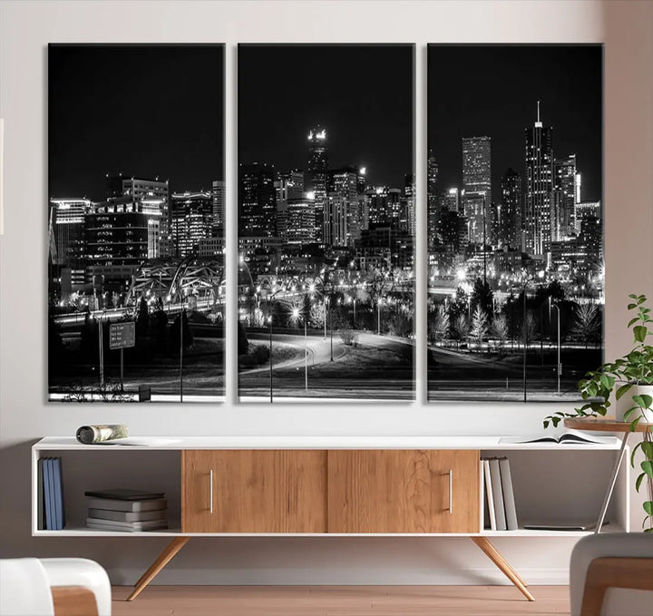 A modern living room featuring the Denver City Lights Skyline Black and White Cityscape Canvas Print above a sofa.