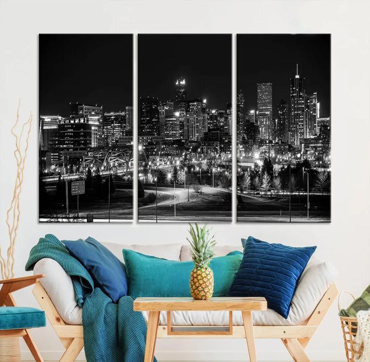 A modern living room featuring the Denver City Lights Skyline Black and White Cityscape Canvas Print above a sofa.