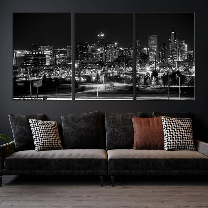 A modern living room featuring the Denver City Lights Skyline Black and White Cityscape Canvas Print above a sofa.