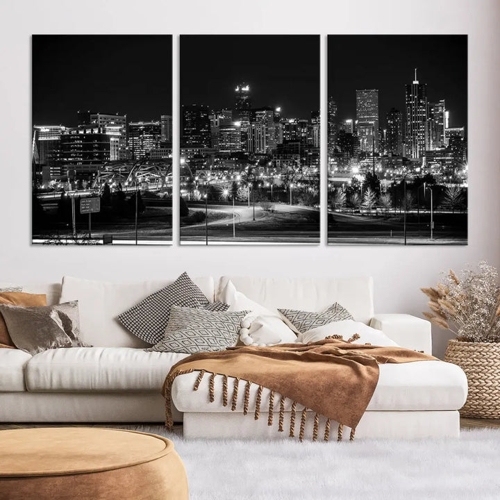 A modern living room featuring the Denver City Lights Skyline Black and White Cityscape Canvas Print above a sofa.