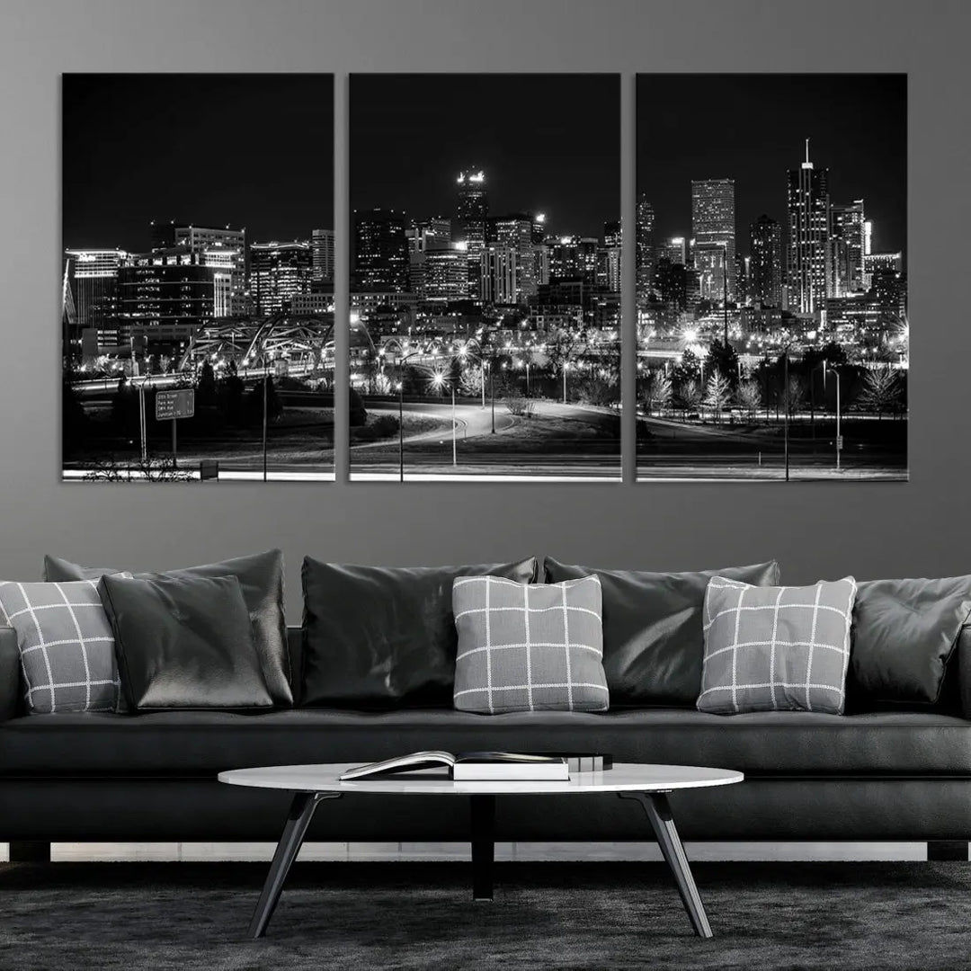 A modern living room featuring the Denver City Lights Skyline Black and White Cityscape Canvas Print above a sofa.