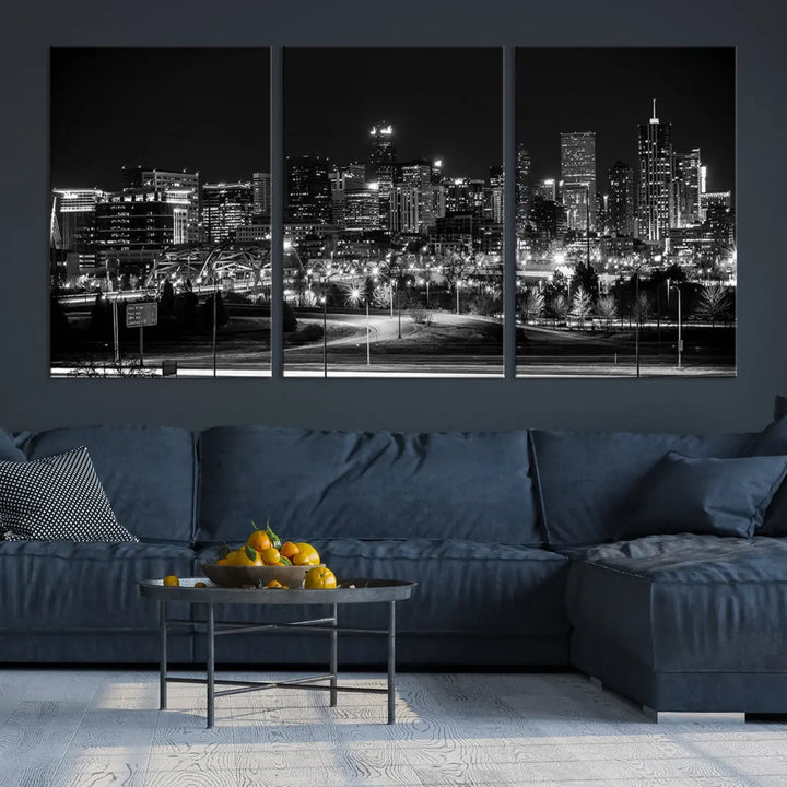 A modern living room featuring the Denver City Lights Skyline Black and White Cityscape Canvas Print above a sofa.