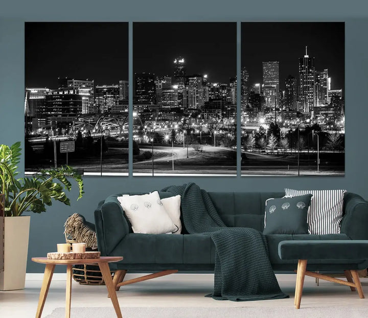 A modern living room featuring the Denver City Lights Skyline Black and White Cityscape Canvas Print above a sofa.