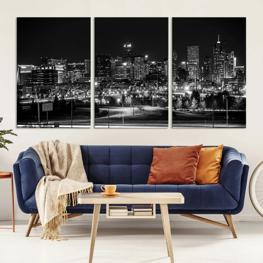 A modern living room featuring the Denver City Lights Skyline Black and White Cityscape Canvas Print above a sofa.