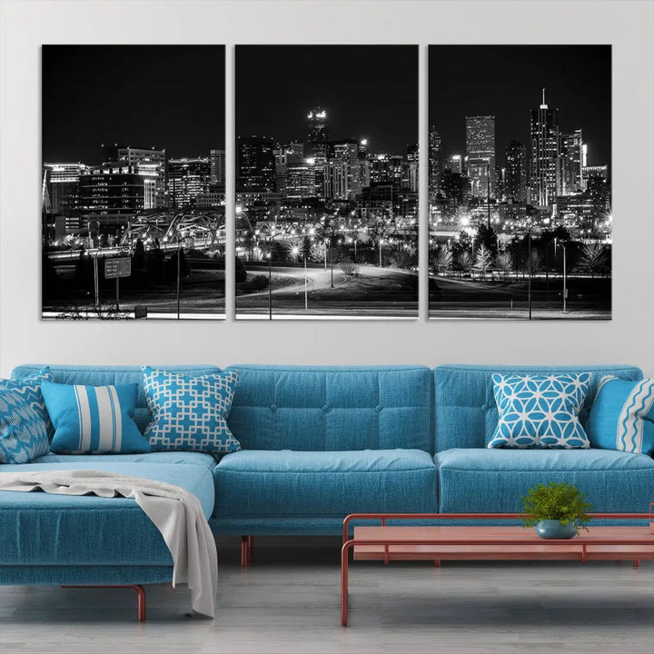 A modern living room featuring the Denver City Lights Skyline Black and White Cityscape Canvas Print above a sofa.