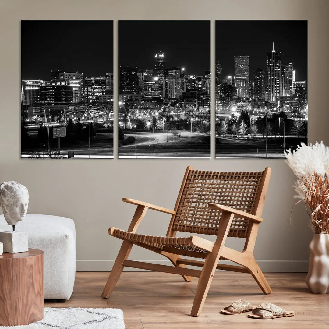 A modern living room featuring the Denver City Lights Skyline Black and White Cityscape Canvas Print above a sofa.