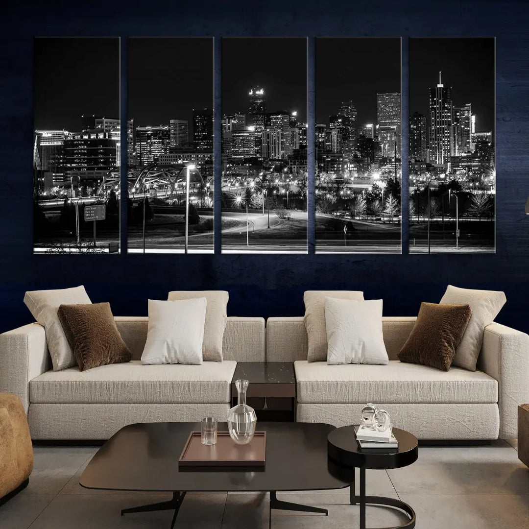 A modern living room featuring the Denver City Lights Skyline Black and White Cityscape Canvas Print above a sofa.