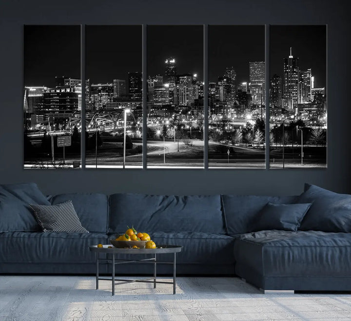 A modern living room featuring the Denver City Lights Skyline Black and White Cityscape Canvas Print above a sofa.