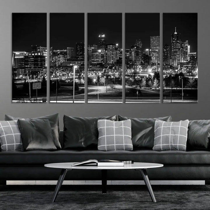 A modern living room featuring the Denver City Lights Skyline Black and White Cityscape Canvas Print above a sofa.