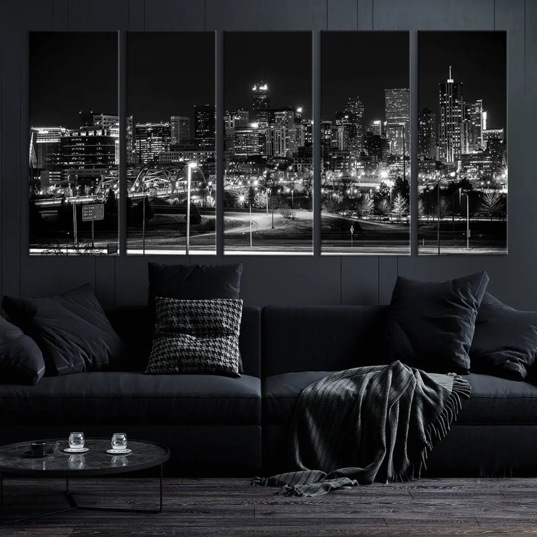 A modern living room featuring the Denver City Lights Skyline Black and White Cityscape Canvas Print above a sofa.