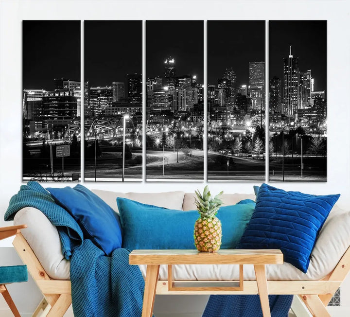 A modern living room featuring the Denver City Lights Skyline Black and White Cityscape Canvas Print above a sofa.