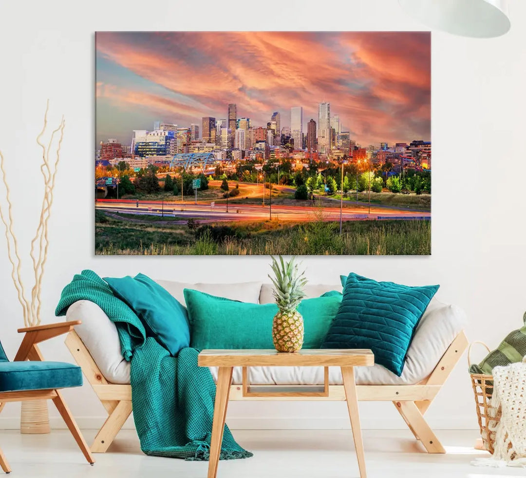 The modern living room showcases the "Denver City Lights Sunset Orange Cloudy Skyline Cityscape View Wall Art Canvas Print," a triptych of museum-quality canvases depicting a city skyline at sunset. This ready-to-hang artwork boasts a UV-protective coating to ensure lasting vibrancy.